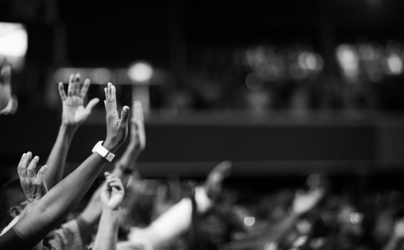 grayscale photography of hands waving