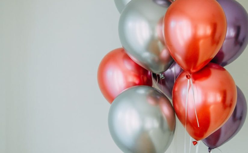 red and white balloons on white wall