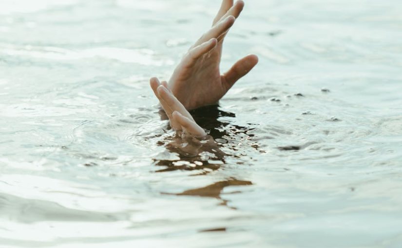 a pair of hands on the surface of water