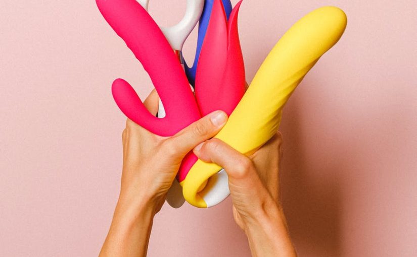 hands holding sex toys