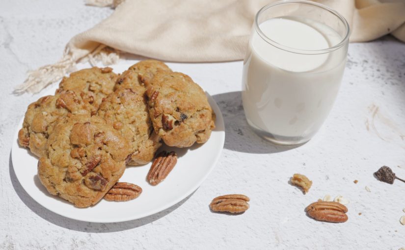 cookies on white ceramic plate beside a glass of milk