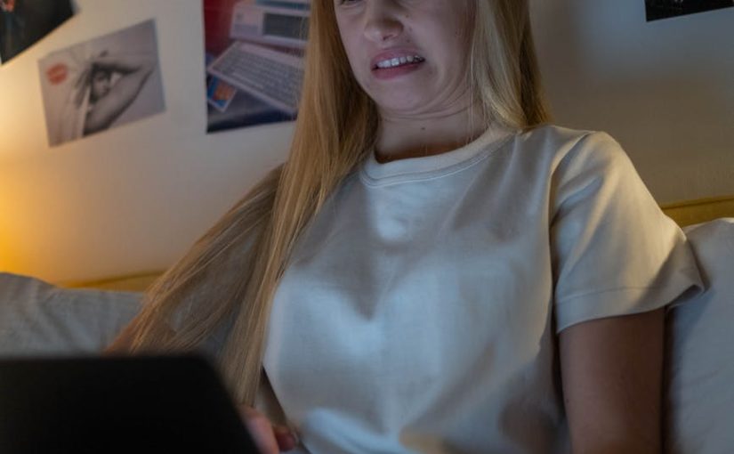 female teenager looking disgusted while watching