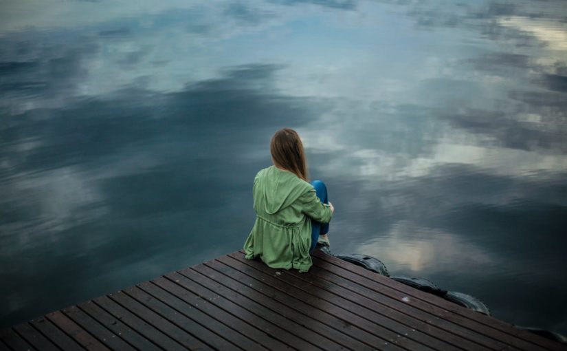 woman sitting on wooden planks