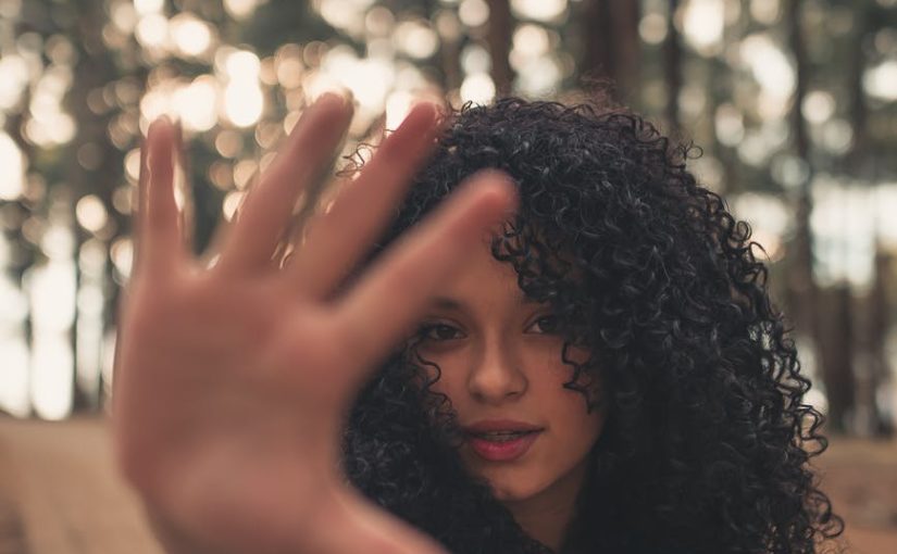 ethnic woman with outstretched arm looking at camera