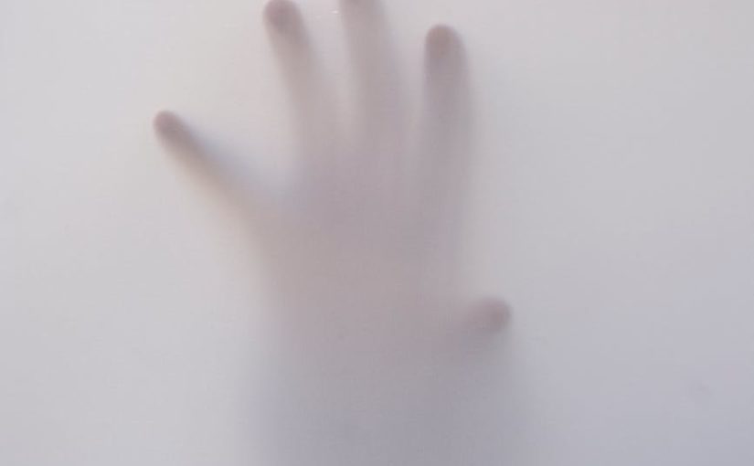 person s hand touching wall