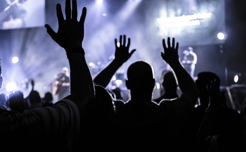 group of people raising hands silhouette photography